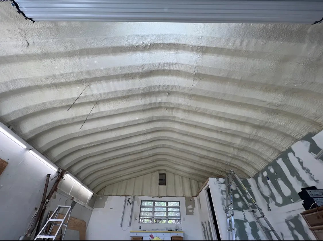 Spray polyurethane foam applied to the underside of a metal roof deck in St. Clair
